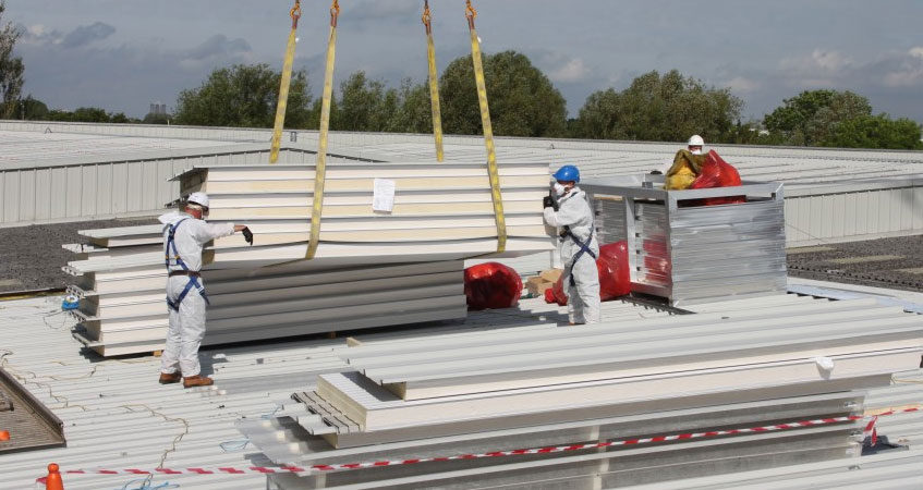 Workers replacing an asbestos roof
