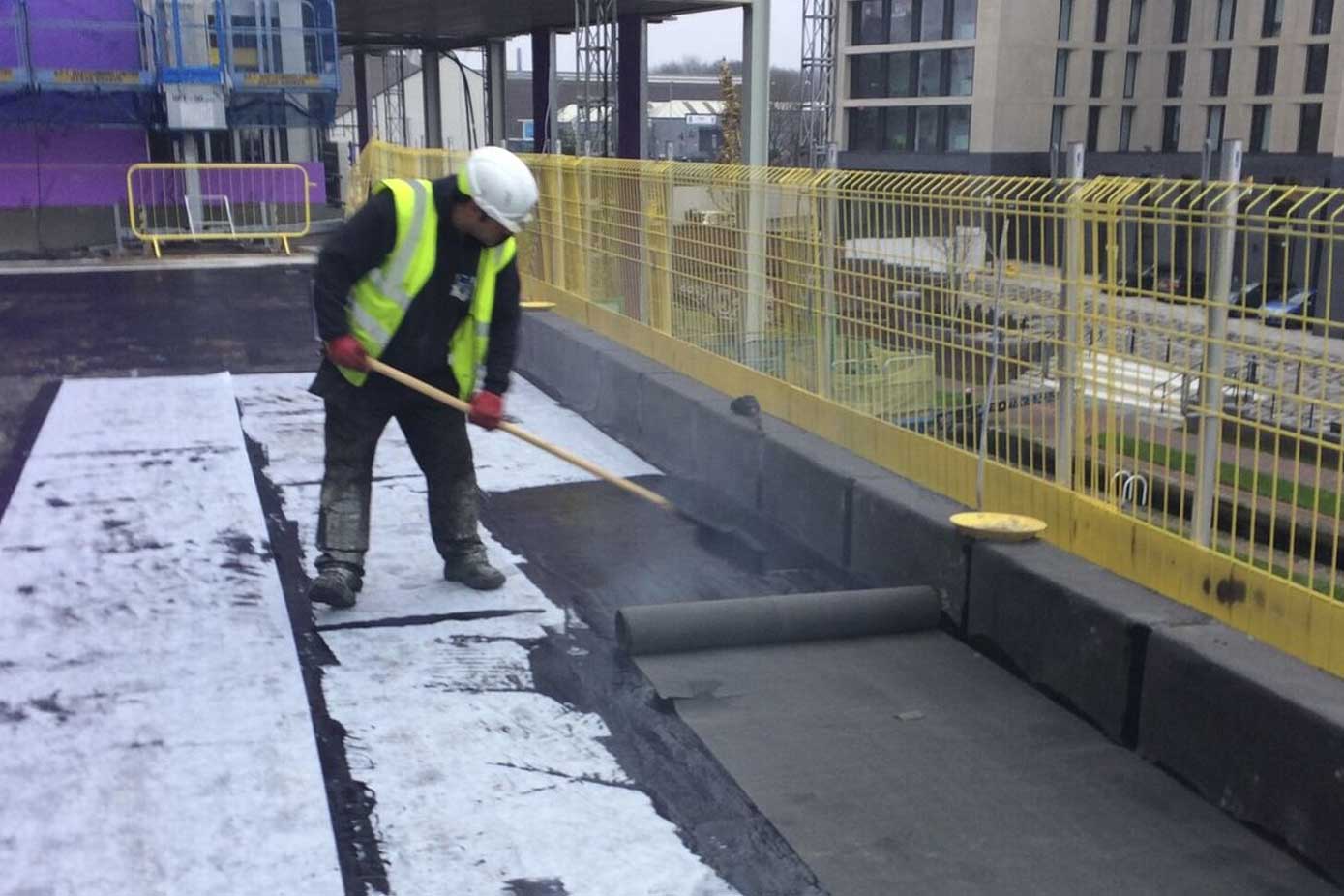 Hot melt roofing installation in progress